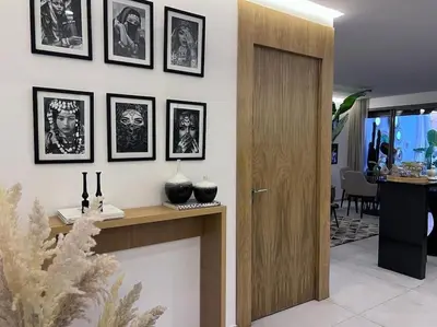 a living room with a wall with pictures on it at S_house in Marrakech