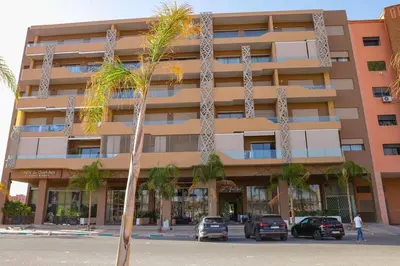 a palm tree in front of a building at S_house in Marrakech