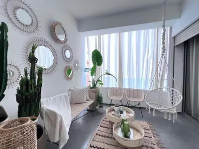 a living room with a couch and chairs and cactus at S_house in Marrakech