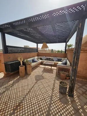a black pergola on top of a patio at maison gueliz in Marrakech