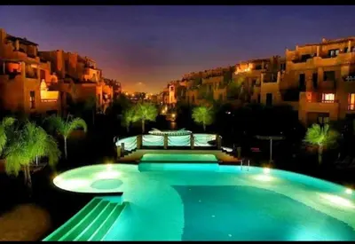 a large swimming pool in front of some buildings at Villa Agdal in Marrakech