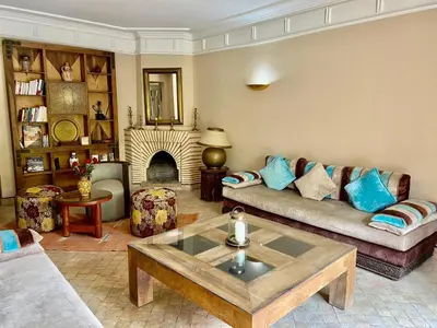 a living room with a couch and a fireplace at Villa Agdal in Marrakech
