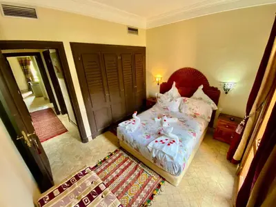 a bedroom with a bed and a rug at Villa Agdal in Marrakech