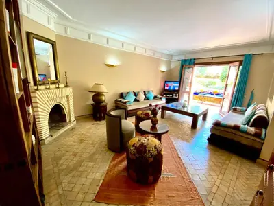 a living room with a couch and a fireplace at Villa Agdal in Marrakech