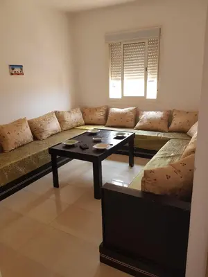 a living room with a couch and a coffee table at appartement Les Palmeraies in Marrakech