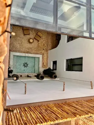 a large white table in a room with windows at Riad Belharra in Marrakech