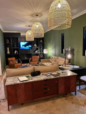 a living room with a couch and a table at Riad Belharra in Marrakech