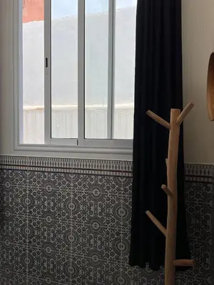 a window in a room with a curtain and a floor at Cosy Appart private riad jemaa el fna in Marrakech