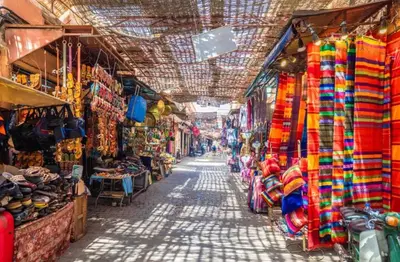 an alley in a market with a bunch of shops at Cosy Appart private riad jemaa el fna in Marrakech