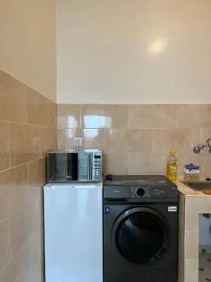a kitchen with a washing machine and a washer at Cosy Appart private riad jemaa el fna in Marrakech