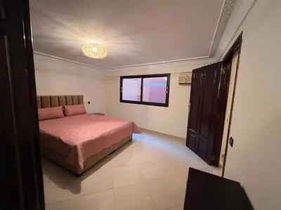 a bedroom with a bed and a window at The Majestic Marrakesh Duplex in Marrakech