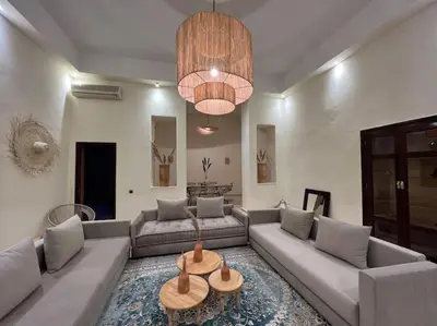 a living room with a couch and a table at The Majestic Marrakesh Duplex in Marrakech