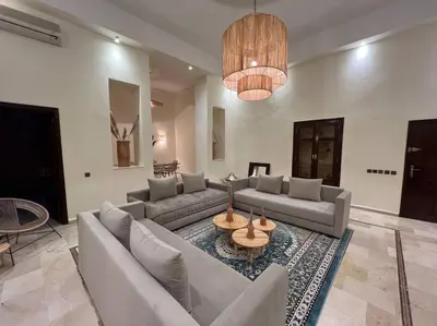 a large living room with couches and a table at The Majestic Marrakesh Duplex in Marrakech