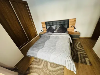 a bedroom with a large bed with a wooden headboard at Glorieux appartement à gueliz in Marrakech