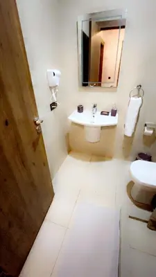 a bathroom with a sink and a toilet and a mirror at Glorieux appartement à gueliz in Marrakech