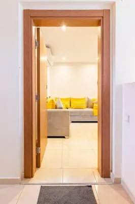 a door leading into a living room with a couch at Magnifique appartement Les perles de marrakech lux avec 2 piscines in Marrakech