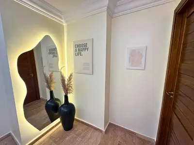 two vases sitting in a hallway with a mirror at Appartement calme, Guéliz in Marrakech