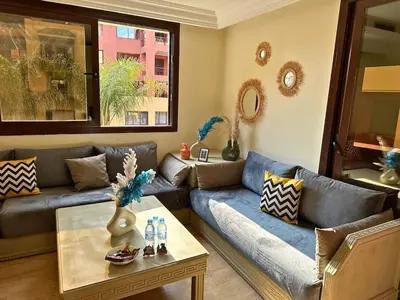 a living room with a couch and a table at Appartement calme, Guéliz in Marrakech