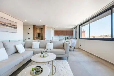 a living room with a couch and a table at Duplex de Luxe Victor Hugo Gueliz in Marrakech