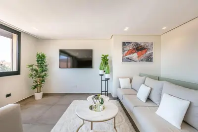 a living room with a white couch and a table at Duplex de Luxe Victor Hugo Gueliz in Marrakech