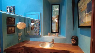 a blue bathroom with a sink and a mirror at Superbe villa avec piscine privée - Golf Amelkis in Marrakech