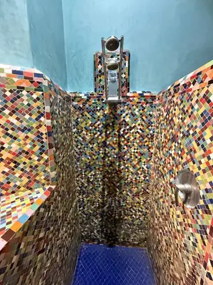a bathroom with a colorful mosaic wall with a shower at Superbe villa avec piscine privée - Golf Amelkis in Marrakech