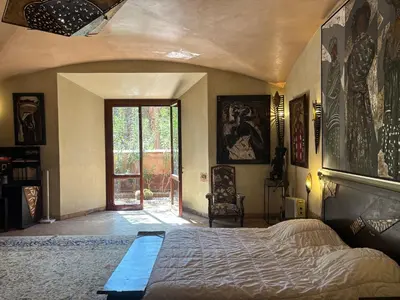 a bedroom with a large bed in a room at Superbe villa avec piscine privée - Golf Amelkis in Marrakech