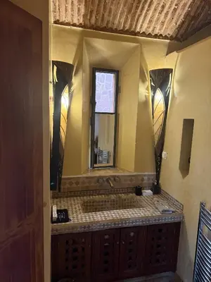 a bathroom with a sink and a mirror at Superbe villa avec piscine privée - Golf Amelkis in Marrakech