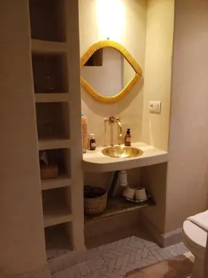 a bathroom with a sink and a mirror at Riad Chambres D'Amis Marrakech in Marrakech