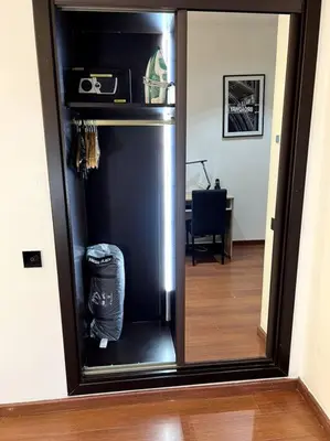 a black refrigerator in a room with a mirror at Appartement Bagatelle in Marrakech
