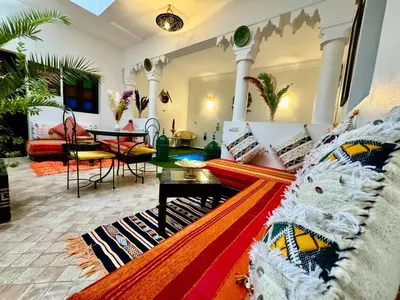 a living room with a couch and a table at Riad Iklil in Marrakech
