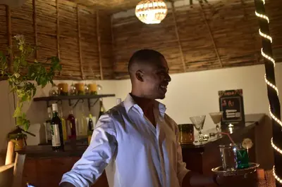 a man standing at a bar smiling at Riad Iklil in Marrakech
