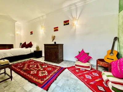 a room with a bed and a guitar in a room at Riad Iklil in Marrakech