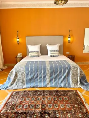 a bed with two pillows on it in a room at Riad Deha & Spa in Marrakech