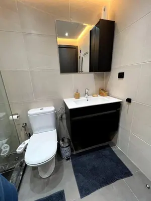 a bathroom with a white toilet and a sink at Luxury apartment in center of gueliz in Marrakech