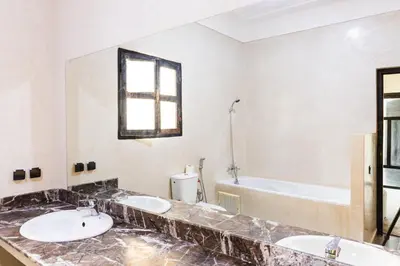 a bathroom with two sinks and a bath tub at Villa Warhol Marrakech in Marrakech