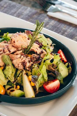 a salad with meat and vegetables in a black bowl at Villa Warhol Marrakech in Marrakech