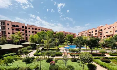 a resort with a pool and trees and buildings at Appartement Marrakech With Pool and View in Marrakech