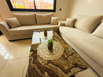 a living room with a couch and a table at Appartement Marrakech With Pool and View in Marrakech