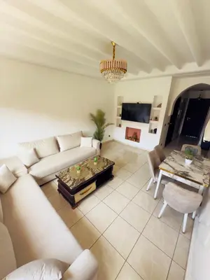 a living room with a couch and a table at Appartement Marrakech With Pool and View in Marrakech