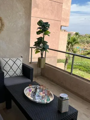 a table with a tray of food on a balcony at Appt Premium 3 rooms with big terrace at Prestigia Marrakech in Marrakech
