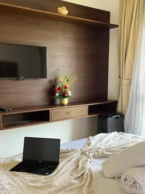 a laptop computer sitting on top of a bed at Appt Premium 3 rooms with big terrace at Prestigia Marrakech in Marrakech