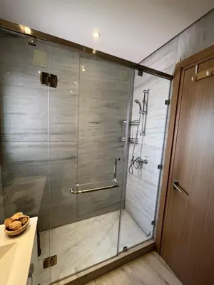a shower with a glass door in a bathroom at Appt Premium 3 rooms with big terrace at Prestigia Marrakech in Marrakech