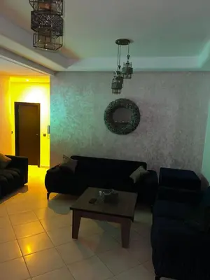 a living room with a couch and a table at Appartement véranda marrakech in Marrakech