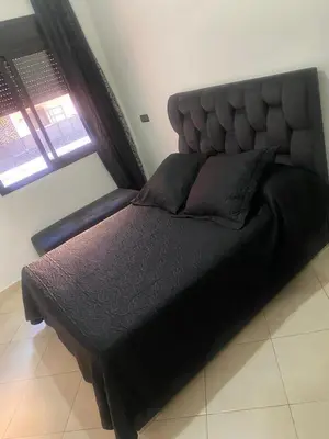 a large black bed in a room with a window at Appartement véranda marrakech in Marrakech