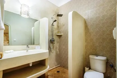 a bathroom with a sink and a toilet and a mirror at Riad Berrima - Breakfast - 10mn from Jamaa Al Fna in Marrakech