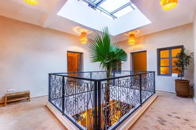 a room with a balcony with a plant at Riad Berrima - Breakfast - 10mn from Jamaa Al Fna in Marrakech