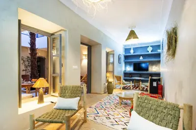 a living room with chairs and a table at Riad Berrima - Breakfast - 10mn from Jamaa Al Fna in Marrakech