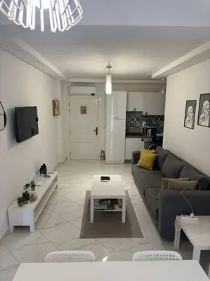 a living room with a couch and a table at appartement center de Guéliz avec piscine in Marrakech