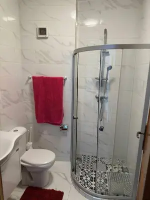 a bathroom with a shower and a toilet and a sink at appartement center de Guéliz avec piscine in Marrakech